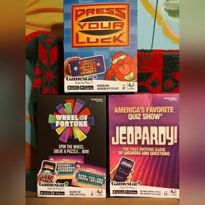 3 unopened boxes includes Jeopardy, Wheel of fortune, Press your Luck